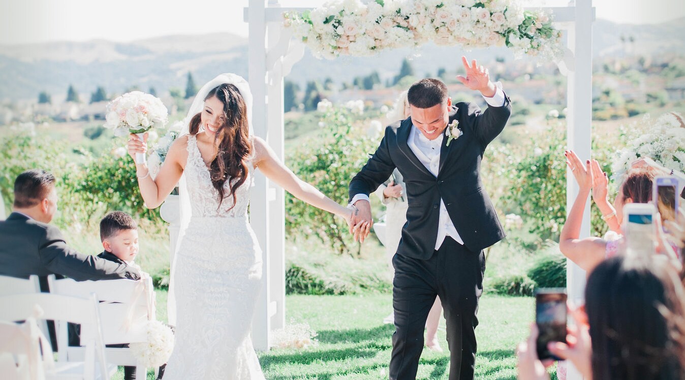 newlywed bride with wedding flowers in hand
